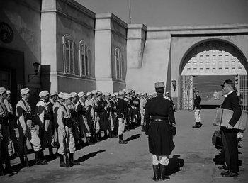 Movie still from “Beau Geste” (1939), directed by William A. Wellman – A black and white photo of a line of men in uniform; Wide shot, Low angle