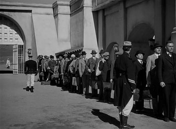 Movie still from “Beau Geste” (1939), directed by William A. Wellman – A black and white photo of a long line of men; Wide shot, High angle