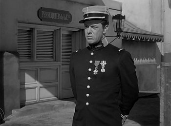 Movie still from “Beau Geste” (1939), directed by William A. Wellman – A black and white photo of a man in a military uniform; Medium shot, Over the shoulder angle
