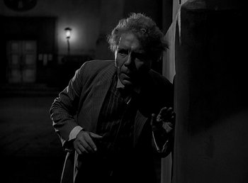 Movie still from “Beau Geste” (1939), directed by William A. Wellman – A black and white photo of a man in a suit and tie; Medium shot, Low angle