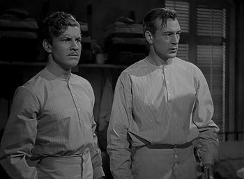 Movie still from “Beau Geste” (1939), directed by William A. Wellman – A couple of men standing next to each other in a room; Medium shot, Low angle