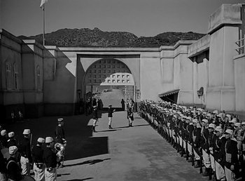 Movie still from “Beau Geste” (1939), directed by William A. Wellman – A black and white photo of a line of men in uniform; Extreme Wide shot, High angle