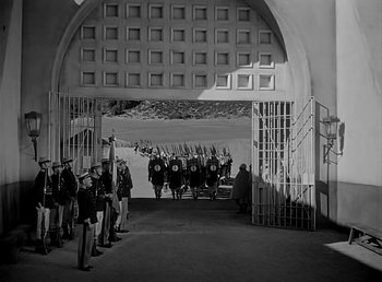 Movie still from “Beau Geste” (1939), directed by William A. Wellman – A black and white photo of a group of men in uniform; Extreme Wide shot, High angle