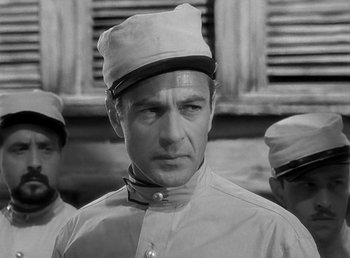 Movie still from “Beau Geste” (1939), directed by William A. Wellman – Black and white photograph of a man wearing a hat; Close Up shot, Over the shoulder angle