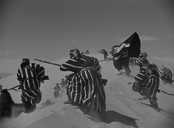 Movie still from “Beau Geste” (1939), directed by William A. Wellman – Black and white photograph of people on a hill; Wide shot, Low angle