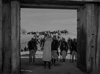 Movie still from “Beau Geste” (1939), directed by William A. Wellman – A black and white photo of a group of men in period dress; Extreme Wide shot, Low angle