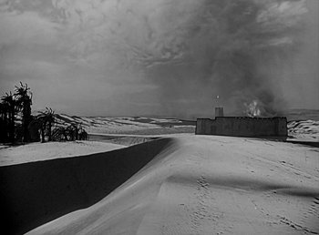 Movie still from “Beau Geste” (1939), directed by William A. Wellman – A black and white photo of a desert landscape; Extreme Wide shot, High angle