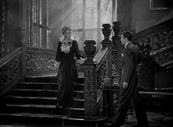 Movie still from “Beau Geste” (1939), directed by William A. Wellman – A man and a woman walking down a set of stairs; Wide shot, High angle