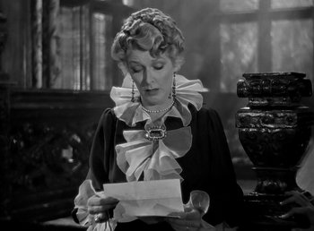 Movie still from “Beau Geste” (1939), directed by William A. Wellman – An older woman is holding an envelope in her hands; Close Up shot, Over the shoulder angle
