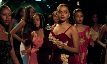 Movie still from “Beau Travail” (1999), directed by Claire Denis – A group of young women standing next to each other; Medium shot, High angle
