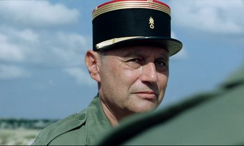 Movie still from “Beau Travail” (1999), directed by Claire Denis – A person wearing a hat; Close Up shot, Low angle