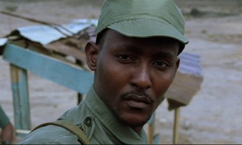 Movie still from “Beau Travail” (1999), directed by Claire Denis – A person wearing a hat; Close Up shot, Low angle
