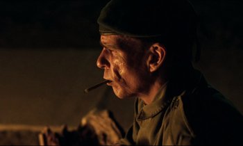 Movie still from “Beau Travail” (1999), directed by Claire Denis – A man with a cigarette in his mouth; Close Up shot, Low angle