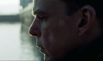 Movie still from “Beau Travail” (1999), directed by Claire Denis – A man's face in the sunlight; Close Up shot, Low angle