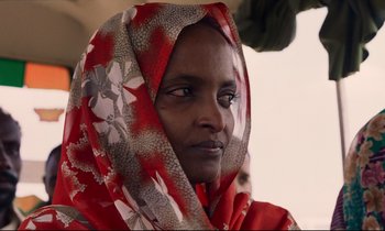 Movie still from “Beau Travail” (1999), directed by Claire Denis – A person wearing a scarf; Close Up shot, Low angle