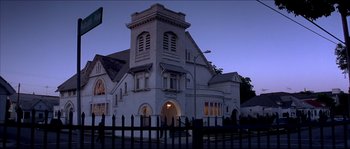 Movie still from “Beauty Shop” (2005), directed by Bille Woodruff – A large white building with a large arched window; Extreme Wide shot, Low angle