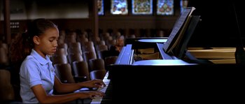 Movie still from “Beauty Shop” (2005), directed by Bille Woodruff – A person playing the piano in a large room; Medium shot, High angle