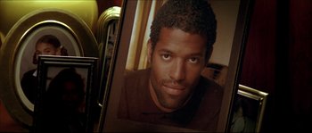 Movie still from “Beauty Shop” (2005), directed by Bille Woodruff – A picture of a man in a brown shirt; Close Up shot, High angle