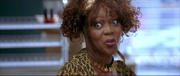 Movie still from “Beauty Shop” (2005), directed by Bille Woodruff – A person wearing a leopard print shirt; Close Up shot, Low angle