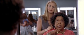 Movie still from “Beauty Shop” (2005), directed by Bille Woodruff – A woman standing in front of another woman in a room; Close Up shot, Over the shoulder angle