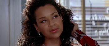 Movie still from “Beauty Shop” (2005), directed by Bille Woodruff – A person with curly black hair; Close Up shot, High angle