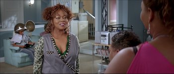 Movie still from “Beauty Shop” (2005), directed by Bille Woodruff – An older woman is talking to a younger man in a living room; Medium shot, Over the shoulder angle