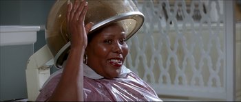Movie still from “Beauty Shop” (2005), directed by Bille Woodruff – A woman with a hair dryer on top of her head; Close Up shot, Over the shoulder angle