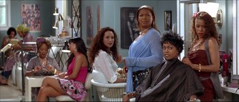 Movie still from “Beauty Shop” (2005), directed by Bille Woodruff – A group of women standing in a room; Medium shot, Over the shoulder angle