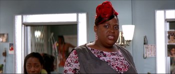 Movie still from “Beauty Shop” (2005), directed by Bille Woodruff – A woman wearing a red hat with a flower on it; Close Up shot, Over the shoulder angle