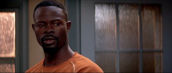 Movie still from “Beauty Shop” (2005), directed by Bille Woodruff – A person wearing an orange shirt; Close Up shot, Over the shoulder angle