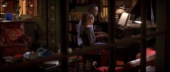 Movie still from “Beauty Shop” (2005), directed by Bille Woodruff – A man and a woman playing a piano in a living room; Medium shot, High angle