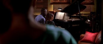 Movie still from “Beauty Shop” (2005), directed by Bille Woodruff – A man and a woman sitting in front of a piano; Medium shot, Over the shoulder angle
