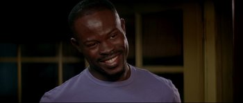 Movie still from “Beauty Shop” (2005), directed by Bille Woodruff – A person wearing a purple shirt; Close Up shot, Low angle