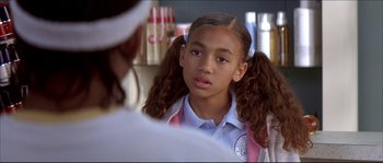 Movie still from “Beauty Shop” (2005), directed by Bille Woodruff – A young girl with pigtails is looking at a doctor; Close Up shot, Over the shoulder angle