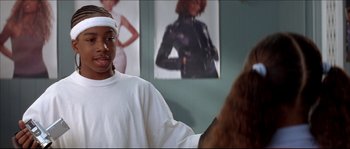 Movie still from “Beauty Shop” (2005), directed by Bille Woodruff – A man standing in front of a mirror in a room; Close Up shot, Over the shoulder angle