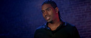 Movie still from “Beauty Shop” (2005), directed by Bille Woodruff – A person wearing a black shirt; Close Up shot, Over the shoulder angle