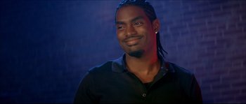 Movie still from “Beauty Shop” (2005), directed by Bille Woodruff – A person with long dreadlocks smiling; Close Up shot, High angle