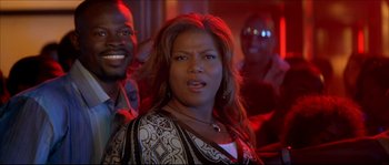 Movie still from “Beauty Shop” (2005), directed by Bille Woodruff – A person in a room with other people; Close Up shot, Over the shoulder angle