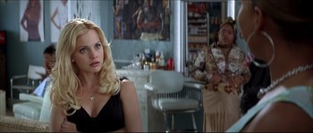Movie still from “Beauty Shop” (2005), directed by Bille Woodruff – Two women sitting in front of each other in a room; Medium shot, Over the shoulder angle