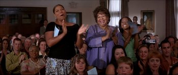 Movie still from “Beauty Shop” (2005), directed by Bille Woodruff – A group of people clapping in front of a window; Medium shot, Low angle