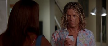 Movie still from “Beauty Shop” (2005), directed by Bille Woodruff – A man with long blonde hair holding a cell phone in his hand; Close Up shot, Over the shoulder angle