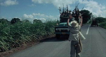 Movie still from “Before Night Falls” (2000), directed by Julian Schnabel – A group of people on the side of the road; Wide shot, Low angle