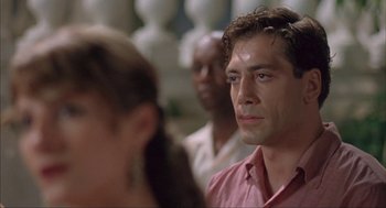 Movie still from “Before Night Falls” (2000), directed by Julian Schnabel – A person wearing a pink shirt; Close Up shot, Over the shoulder angle