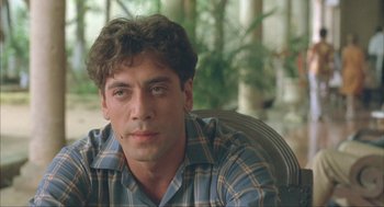 Movie still from “Before Night Falls” (2000), directed by Julian Schnabel – A person sitting in a chair; Close Up shot, Low angle