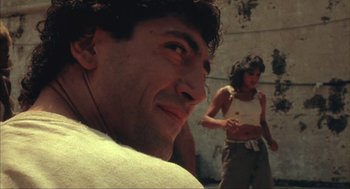 Movie still from “Before Night Falls” (2000), directed by Julian Schnabel – A man and a woman are standing in a room; Close Up shot, Low angle