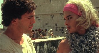 Movie still from “Before Night Falls” (2000), directed by Julian Schnabel – A man and a woman standing next to each other in front of a wall; Close Up shot, Over the shoulder angle