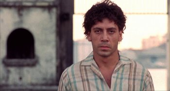 Movie still from “Before Night Falls” (2000), directed by Julian Schnabel – A person wearing a striped shirt; Close Up shot, Low angle