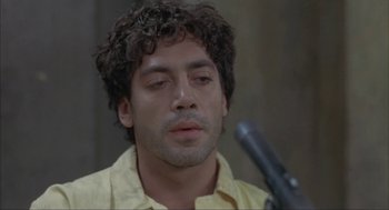 Movie still from “Before Night Falls” (2000), directed by Julian Schnabel – A person with a microphone; Close Up shot, Low angle