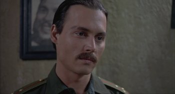 Movie still from “Before Night Falls” (2000), directed by Julian Schnabel – A person with a mustache; Close Up shot, Over the shoulder angle