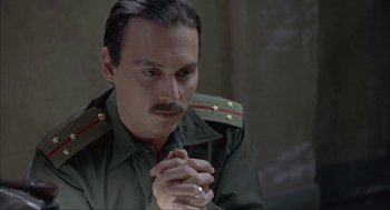 Movie still from “Before Night Falls” (2000), directed by Julian Schnabel – A person wearing a uniform; Close Up shot, High angle